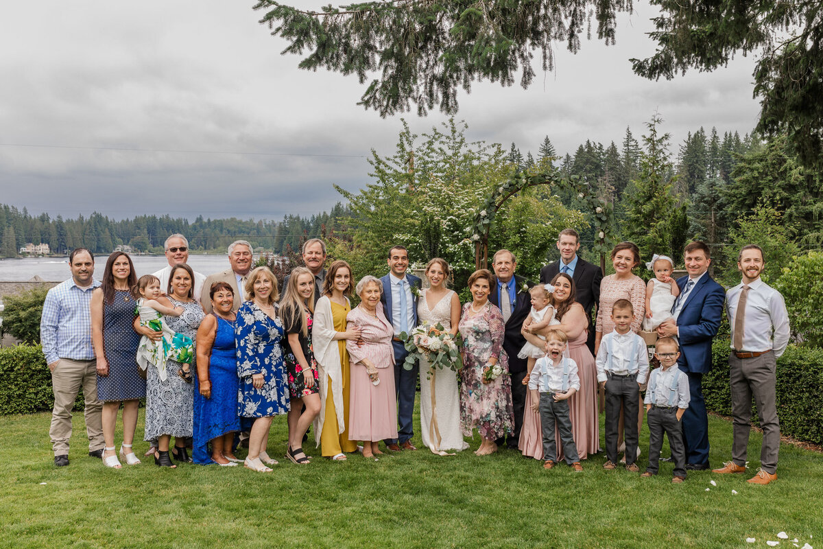 Large-happy-family-group-photo-at-Snohomish-wedding-venue-Green-Gates-at-Flowing-Lake-by-Joanna-Monger-Photography