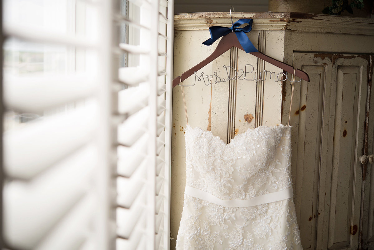 Wedding dress hanging in the hotel room of Oceanbleu