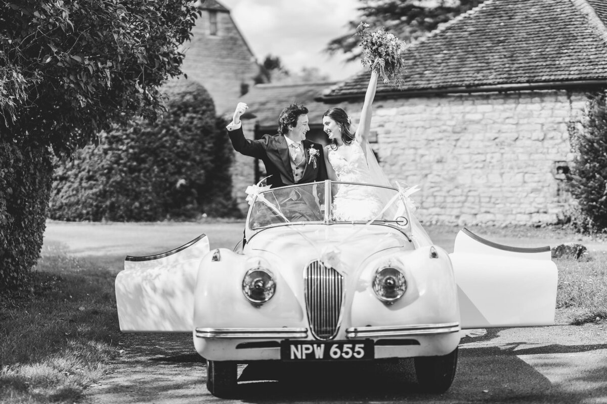 old school car with bride and groom