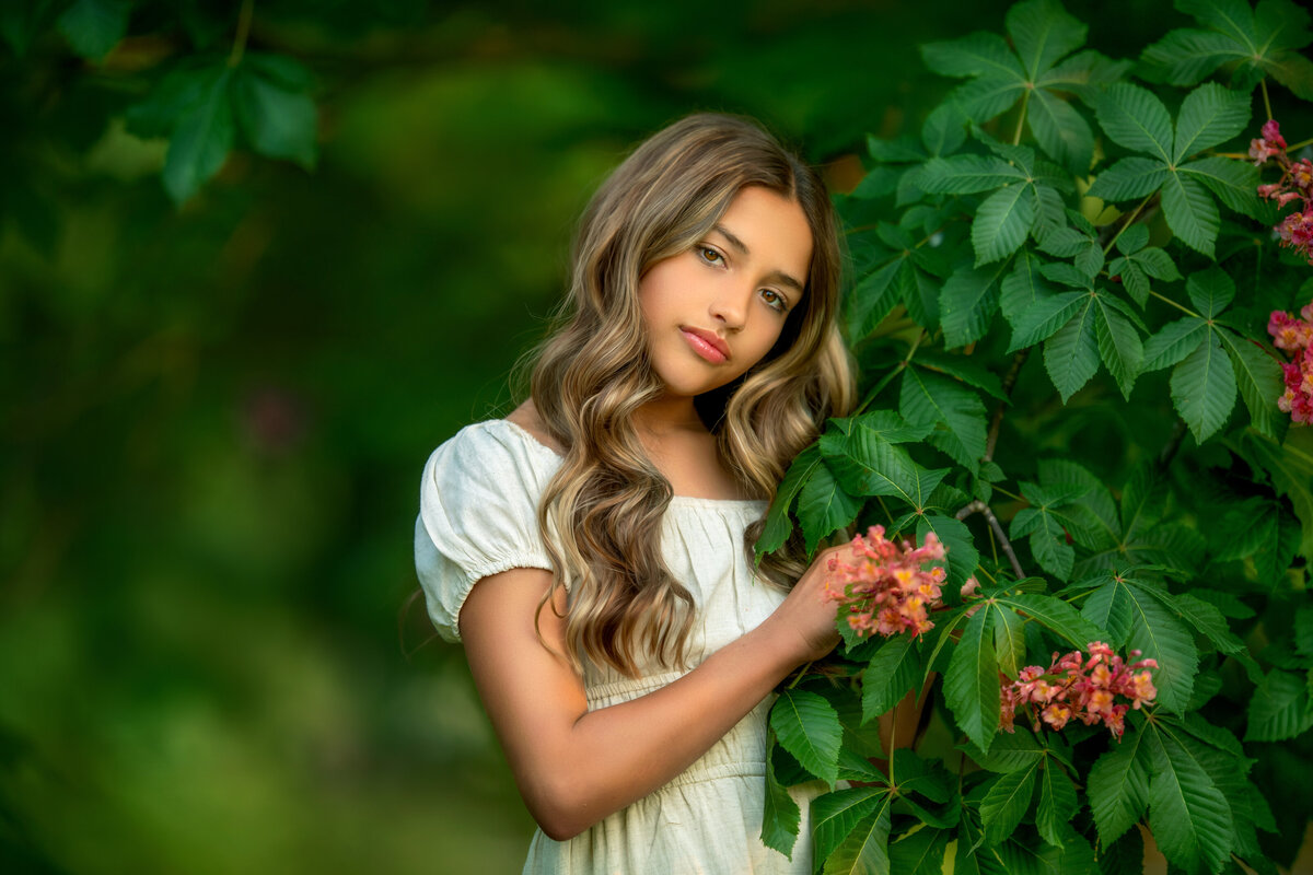 Blooming pink chestnut tree and long hair teen girl