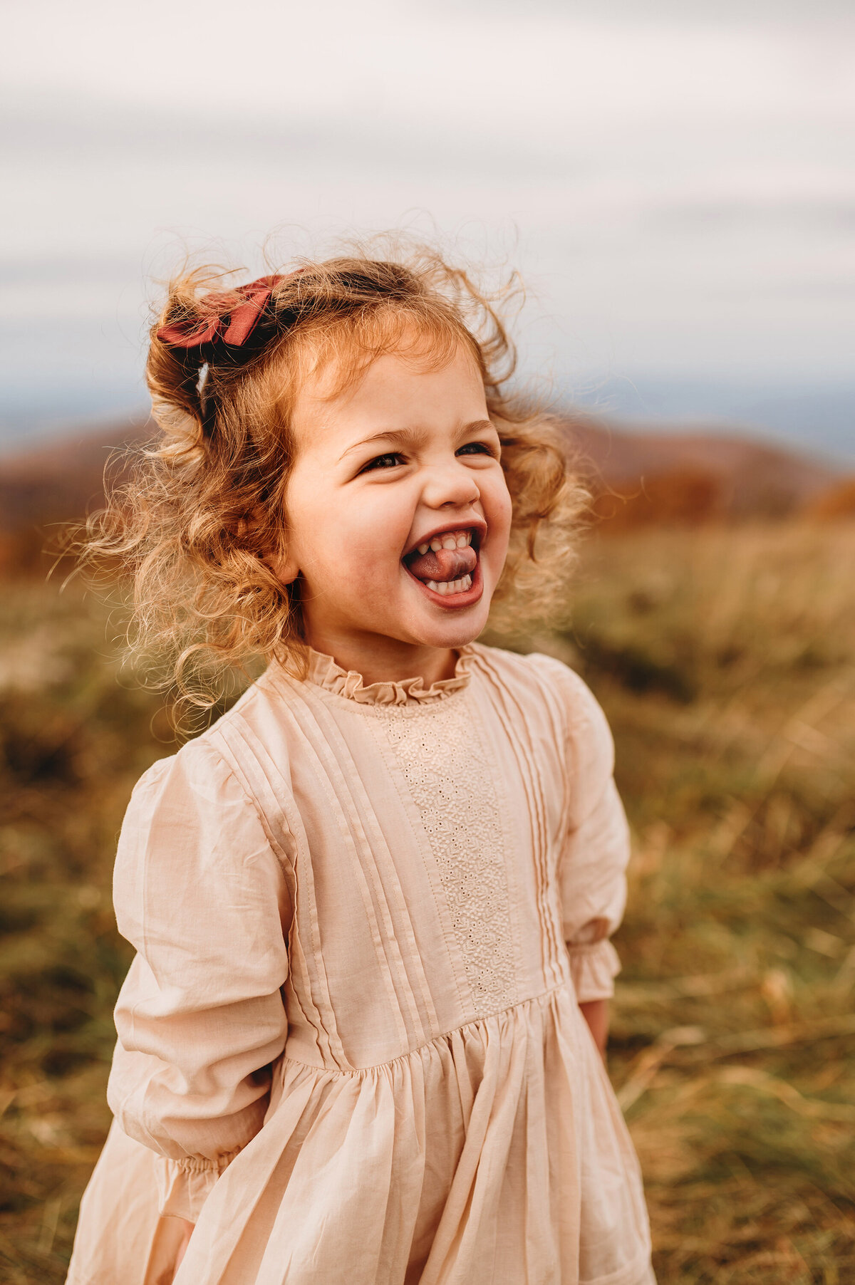 Little girl laughs during Family Photoshoot at Max Patch in Asheville, NC.