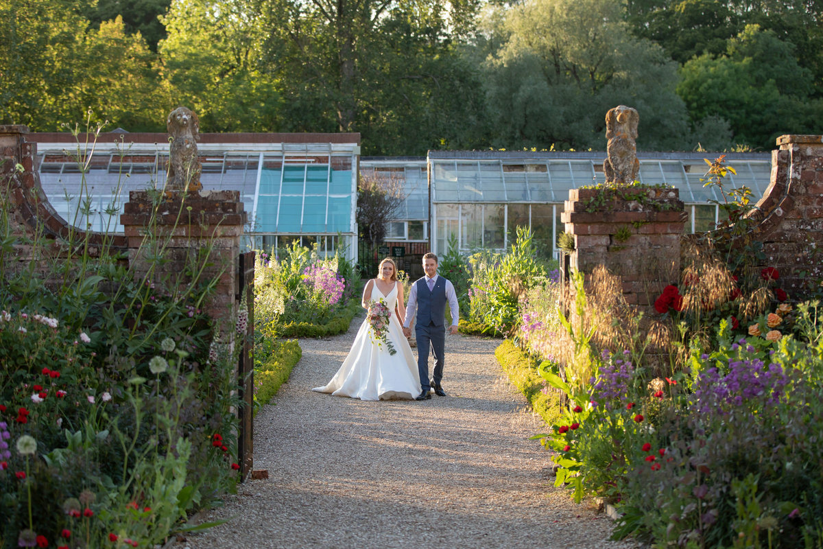 Bride and Groom in front of the greenhouses at Forde House Wedding in Somerset_