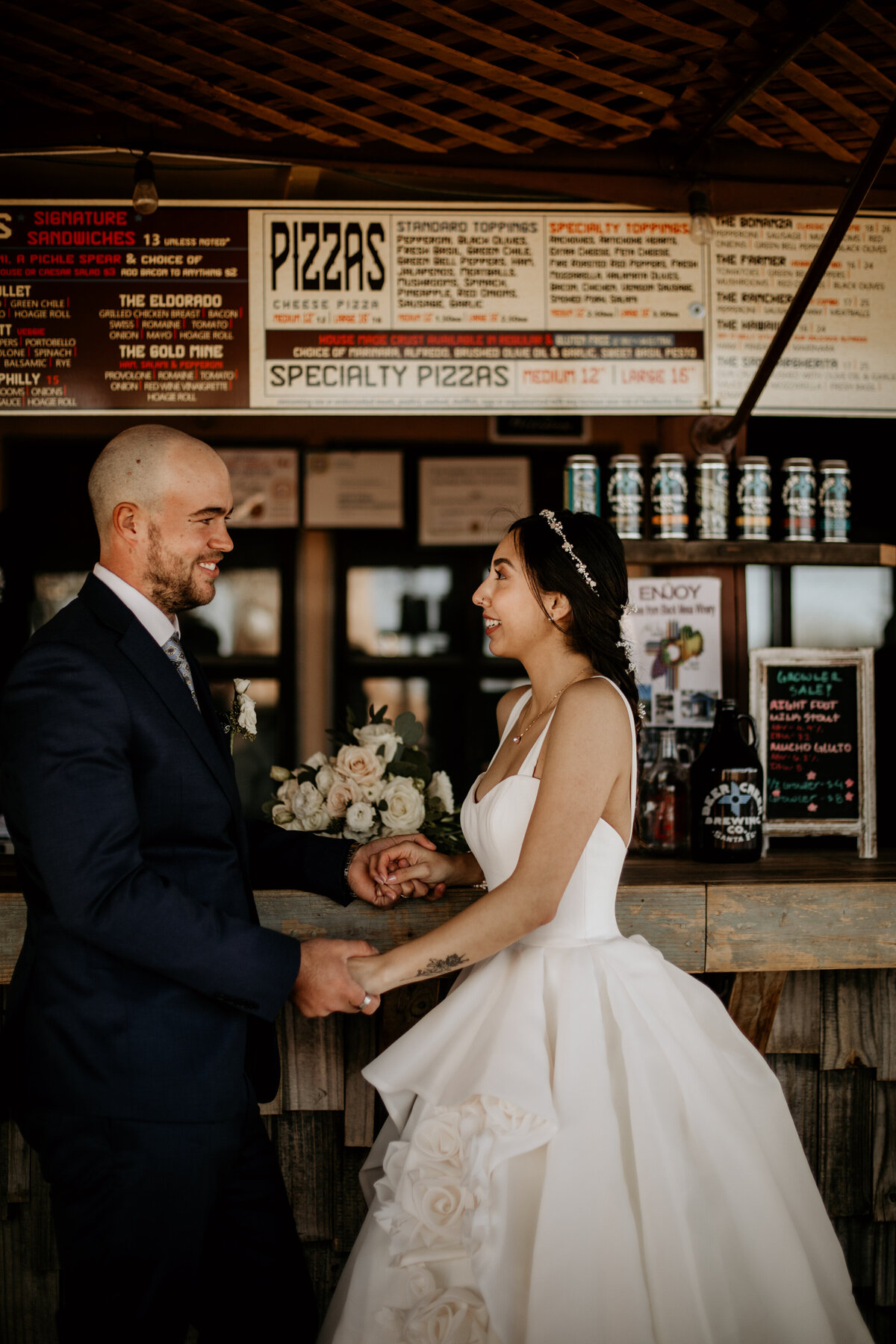 bride and groom standing at a bar together in New Mexico