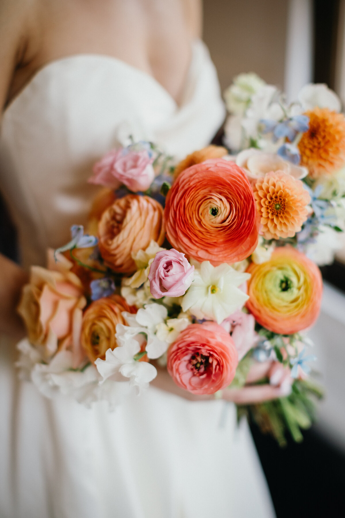 Bride holding beautiful and colorful flower bouquet