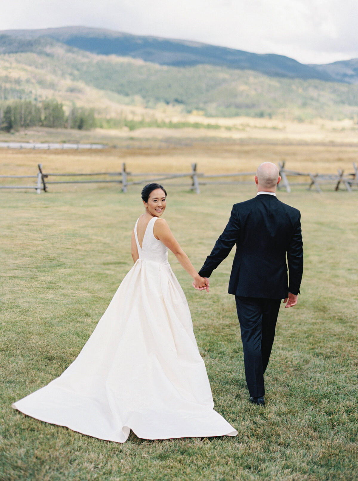 Couple walks at Brush Creek Ranch wedding