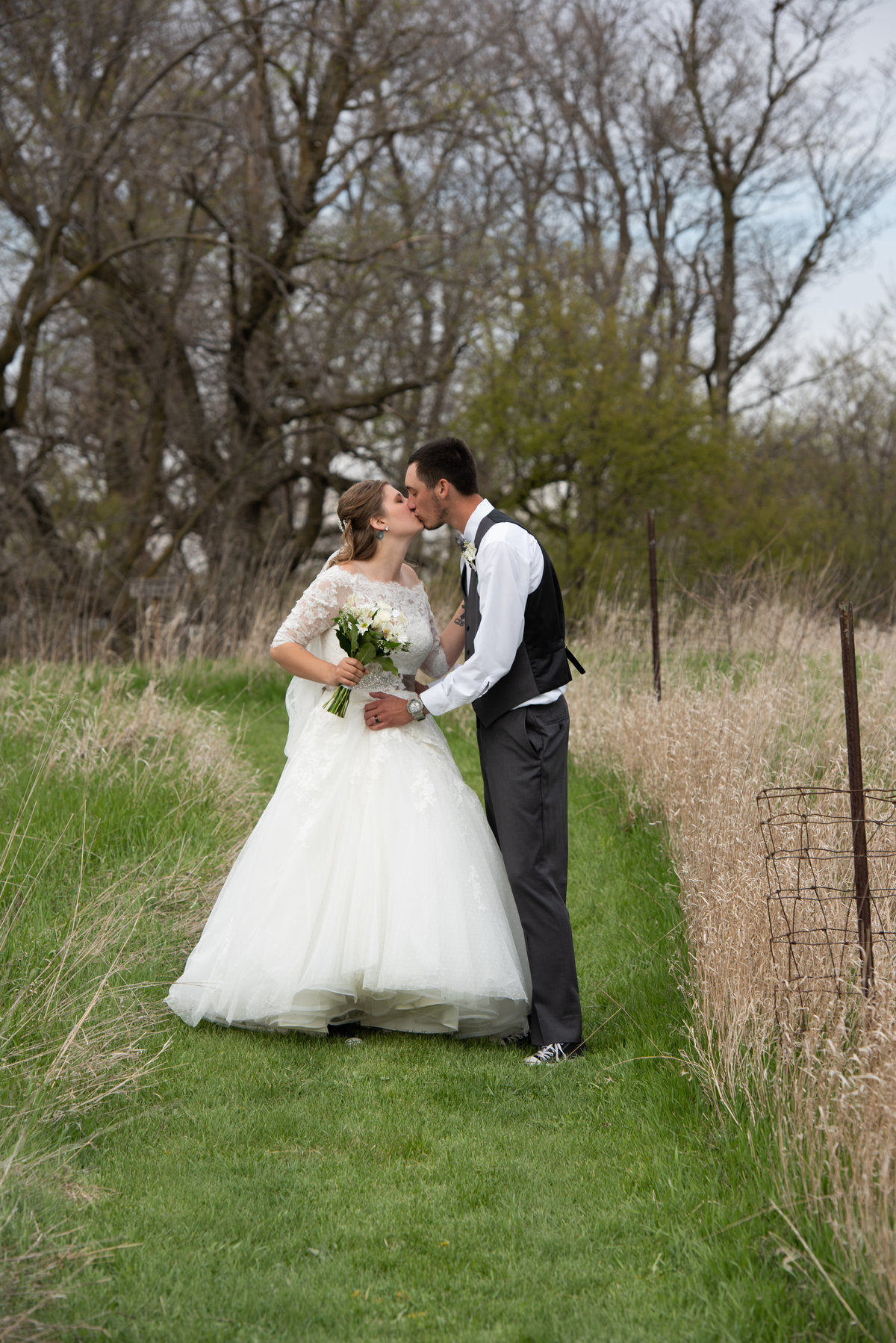 natural grass aisle bride wears sleeves