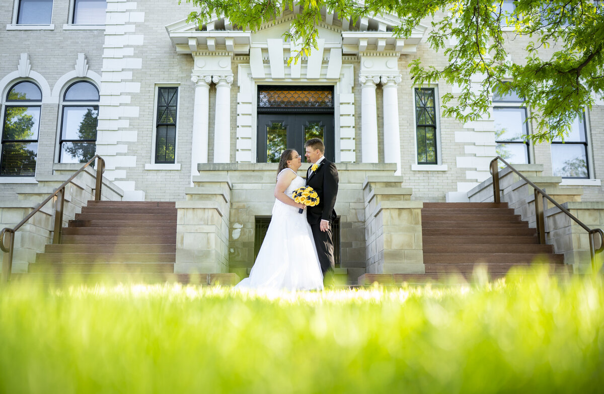 Ten year anniversary portraits in front of courthouse in Sterling Colorado