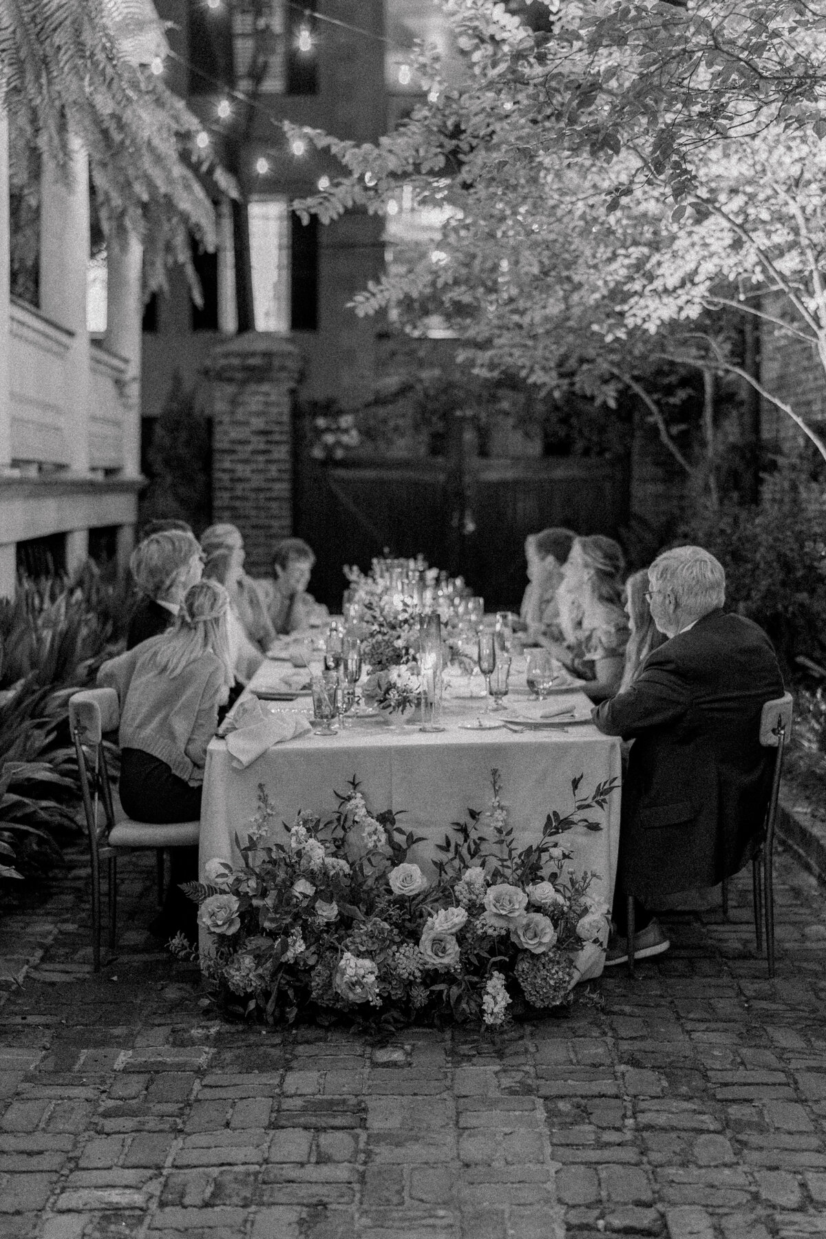 Candlelit intimate wedding reception open air dinner at Parsonage Inn fall wedding. Black and white wedding photographer. Kailee DiMeglio Photography.