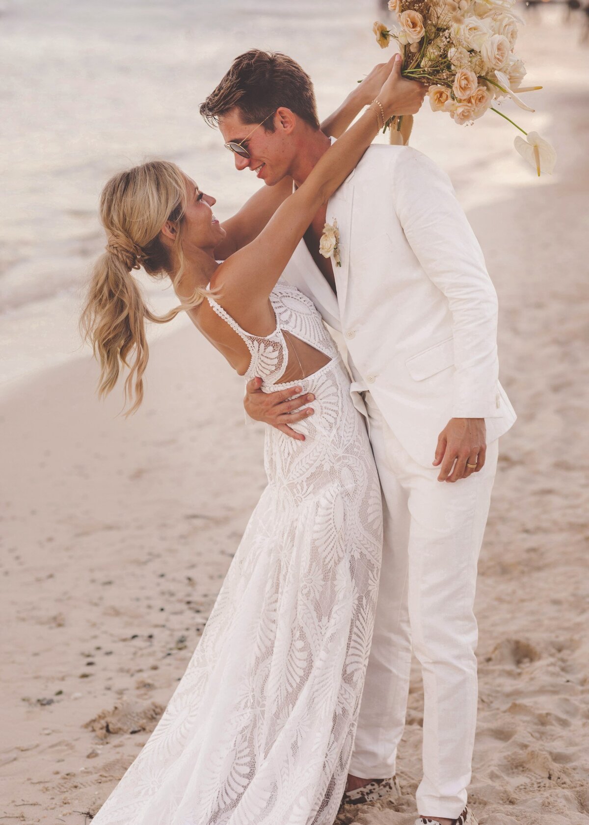 Bride and groom having dun on beach in Riviera Maya