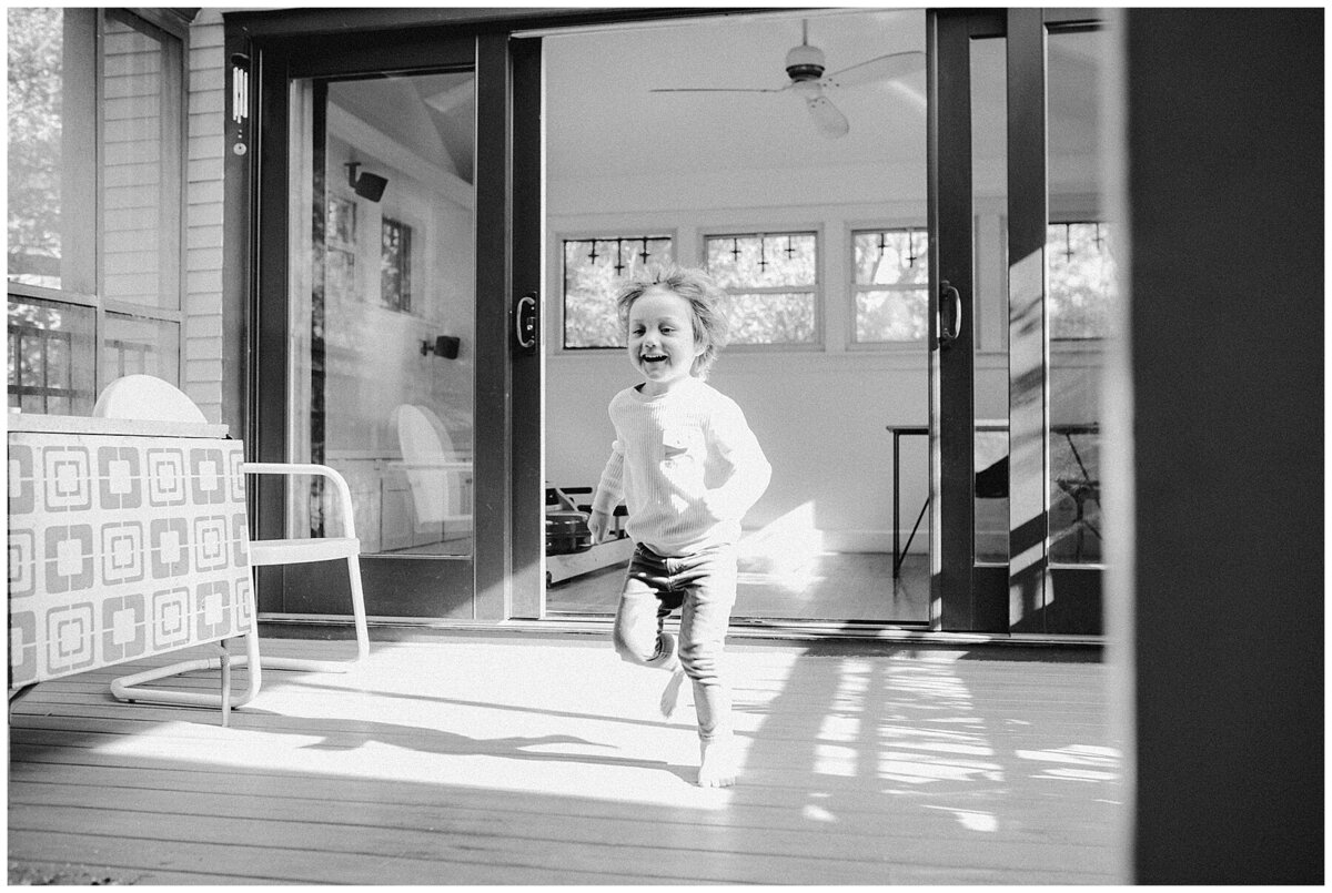 child running through home at sweet home family session in Austin by Amber Vickey Photography