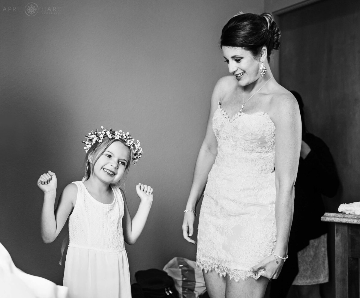 Flower girl is delighted with her flower crown at a Denver wedding in Colorado
