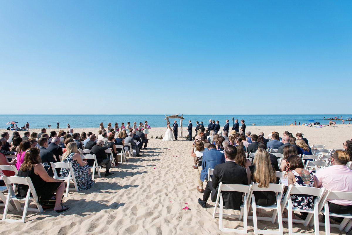 photo of wedding ceremony set up with guests on the beach at Pavilion at Sunken Meadow