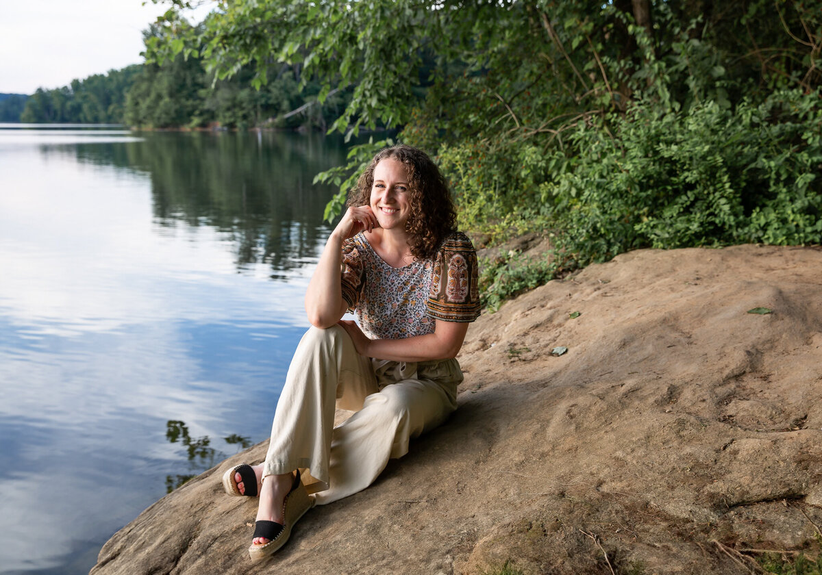 A creative entrepreneur poses at Loch Raven Park in Baltimore, Maryland while Ingrid Berrios, a photographer, takes her personal branding photos by a lake.