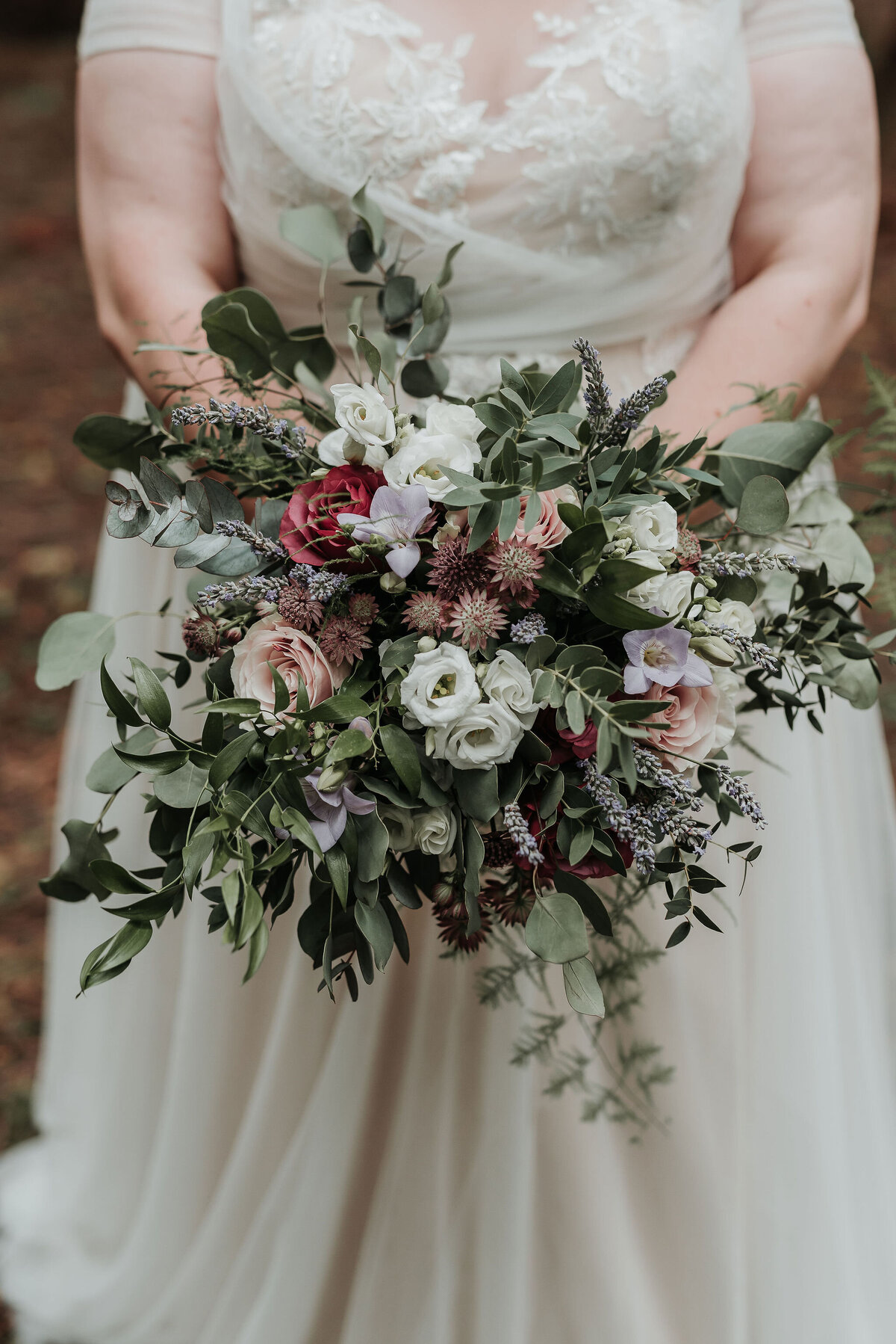 Whimsical bridal bouquet with lilac and cream florals at romantic wedding at Two Woods Estate