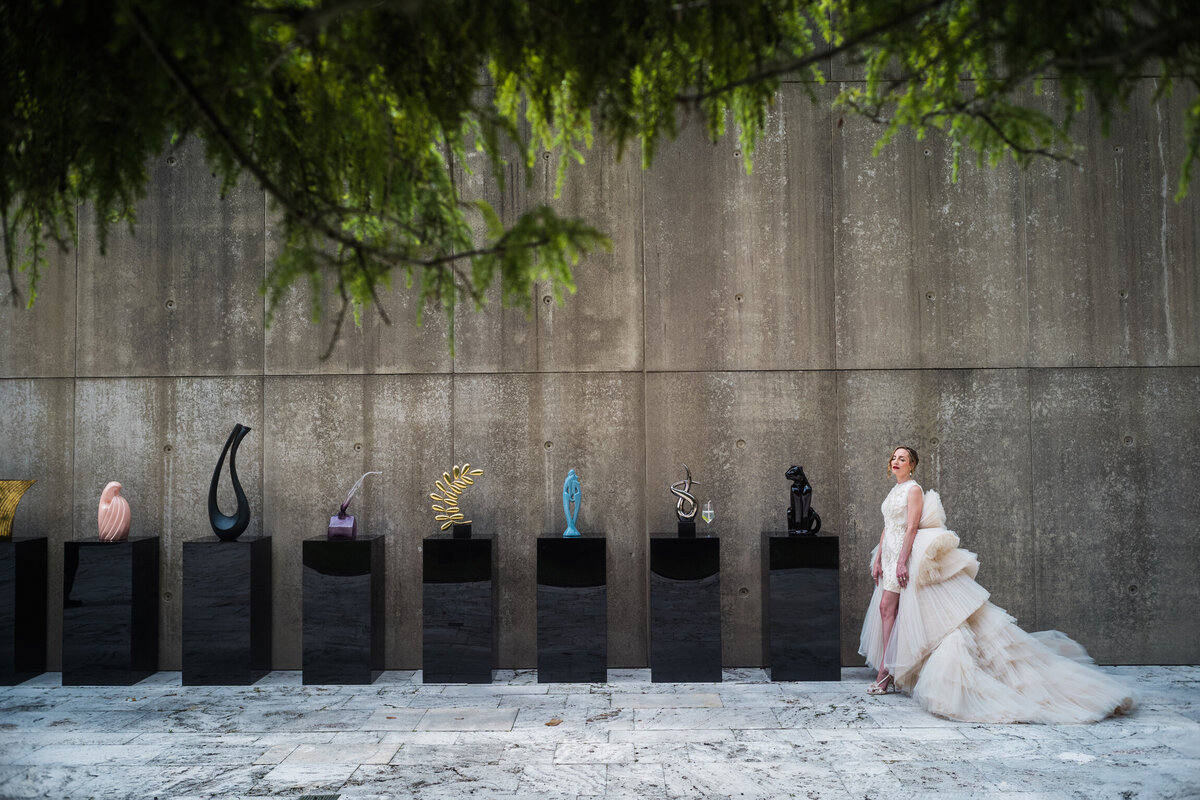 Bridal portrait next to sculptures