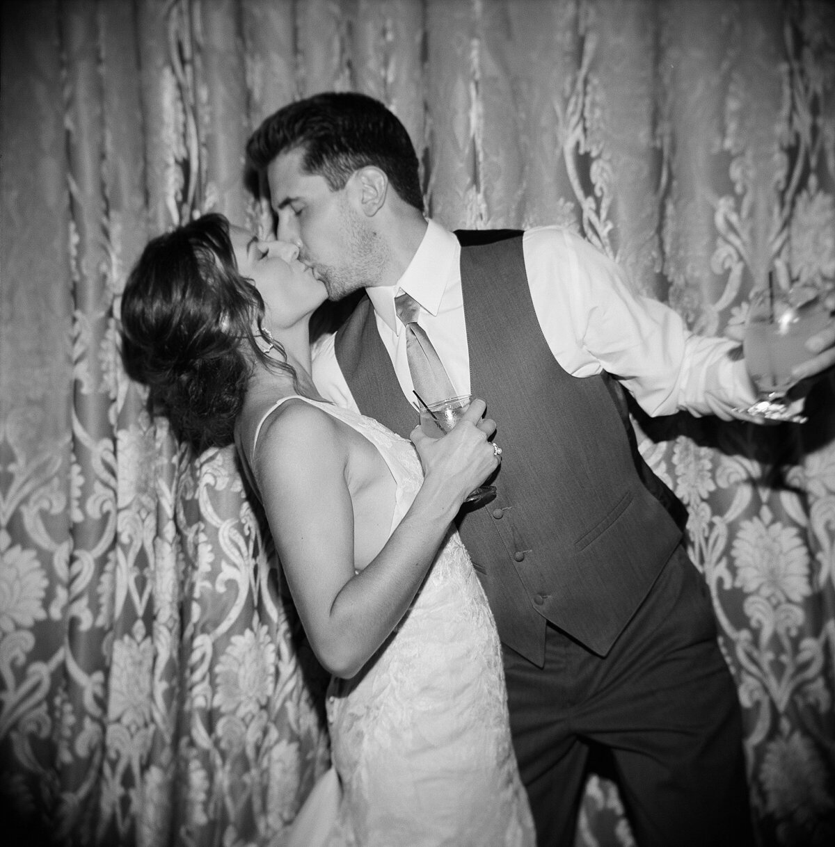 Bride and groom kissing black and white film