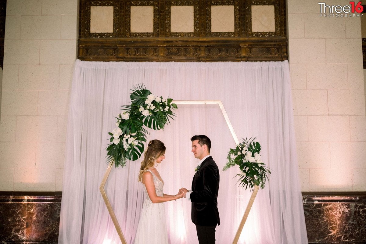 Couple pose in front of the altar after the ceremony