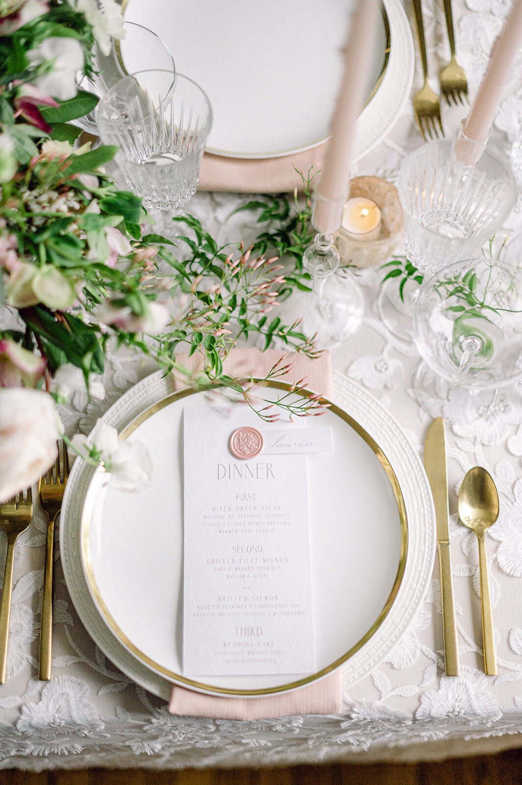 Gold and white place settings at wedding reception