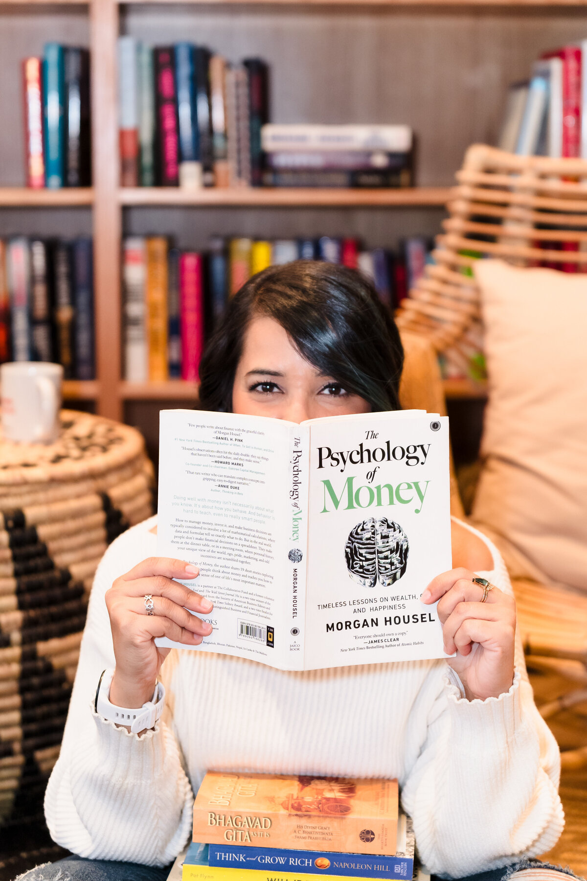 brand photo of a woman holding a book about money mindset