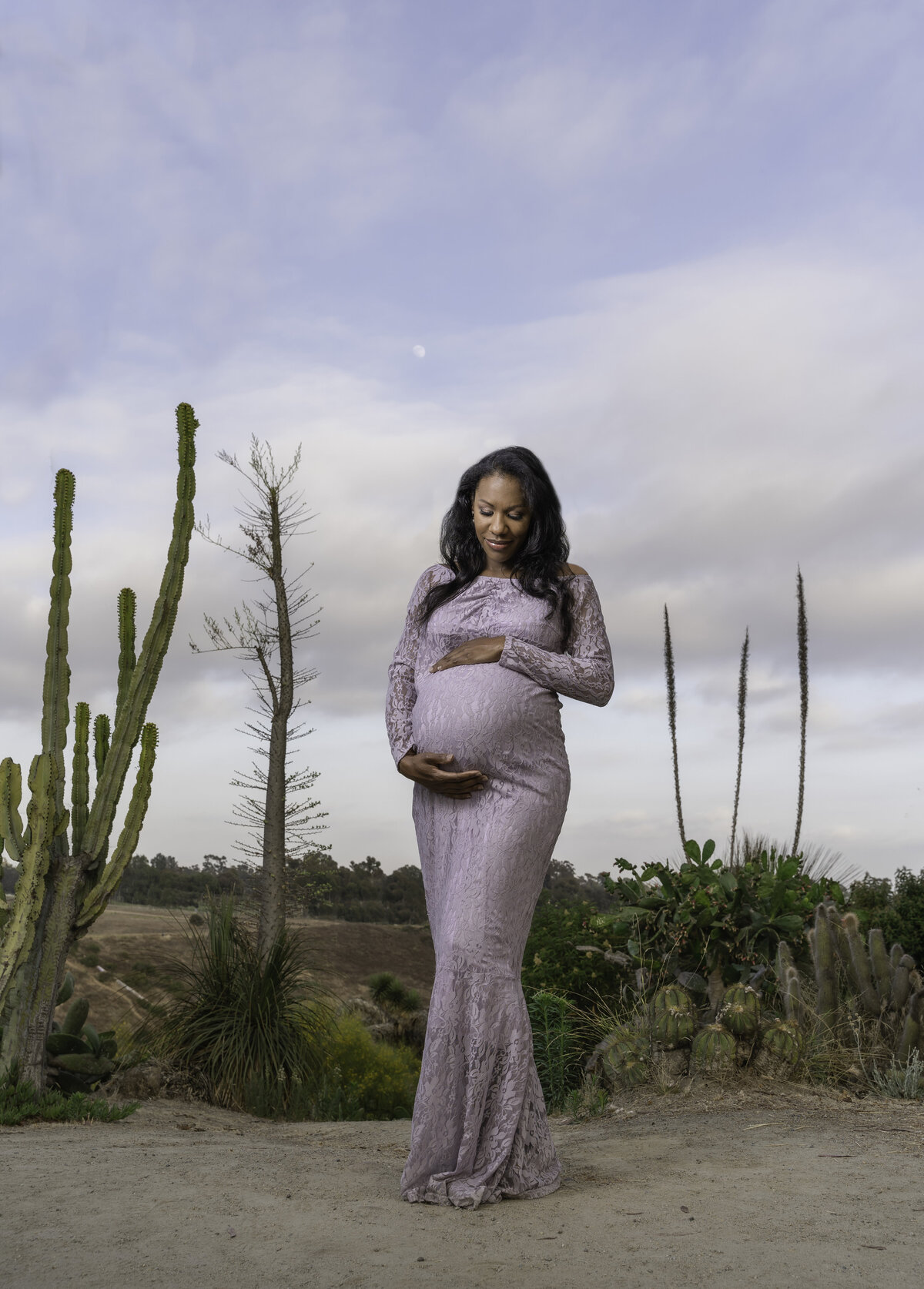 Black pregnant mom to be in purple lace in desert