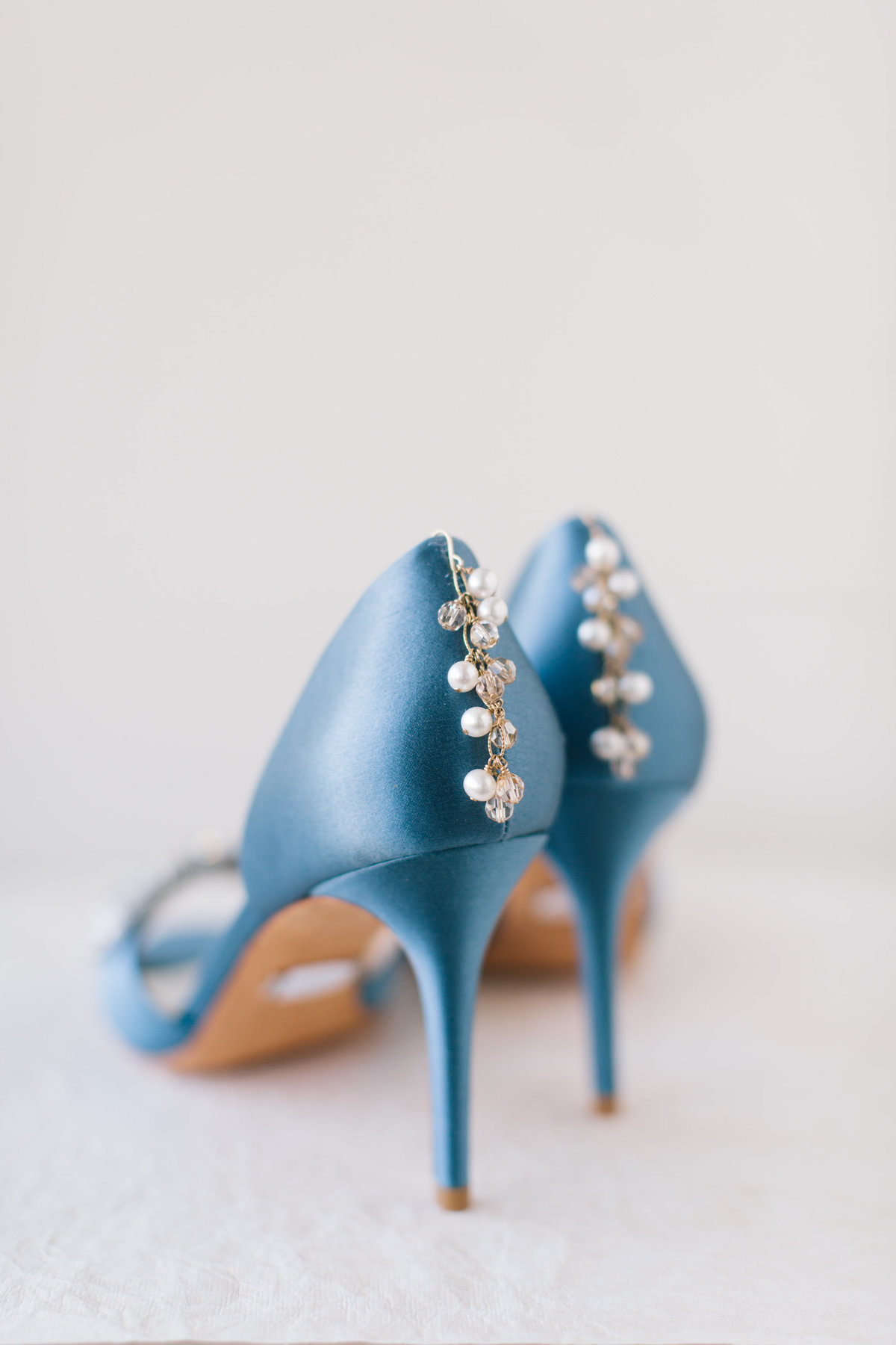 bridal pearl earrings on blue high heels