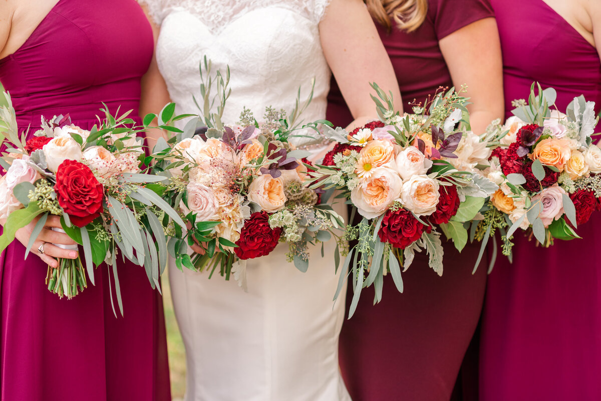 Burgandy, cream, and peach colored Bridal Bouquet with burgandy bridesmaids dresses photographed by Austin TX based Wedding Photographer Lydia Teague
