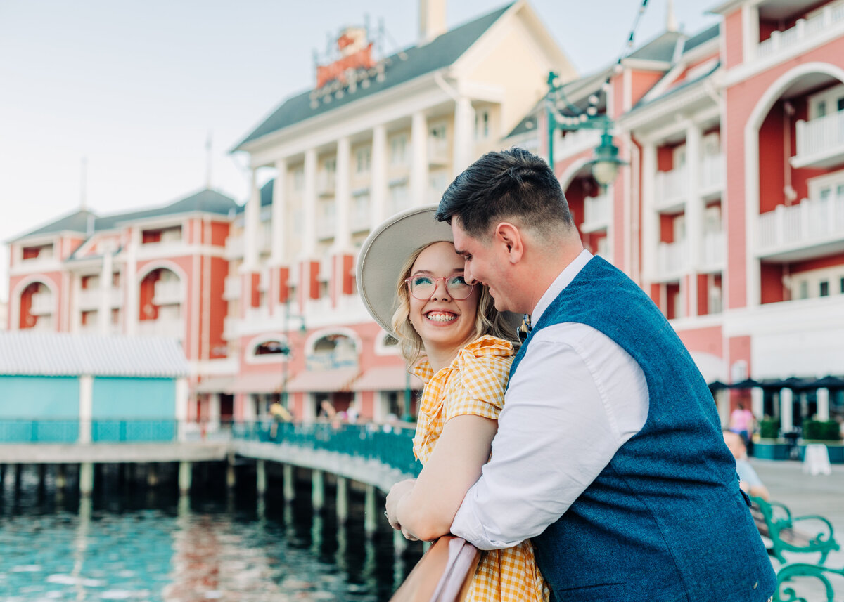 Engagement shoot with couple at railing at Disney's Boardwalk