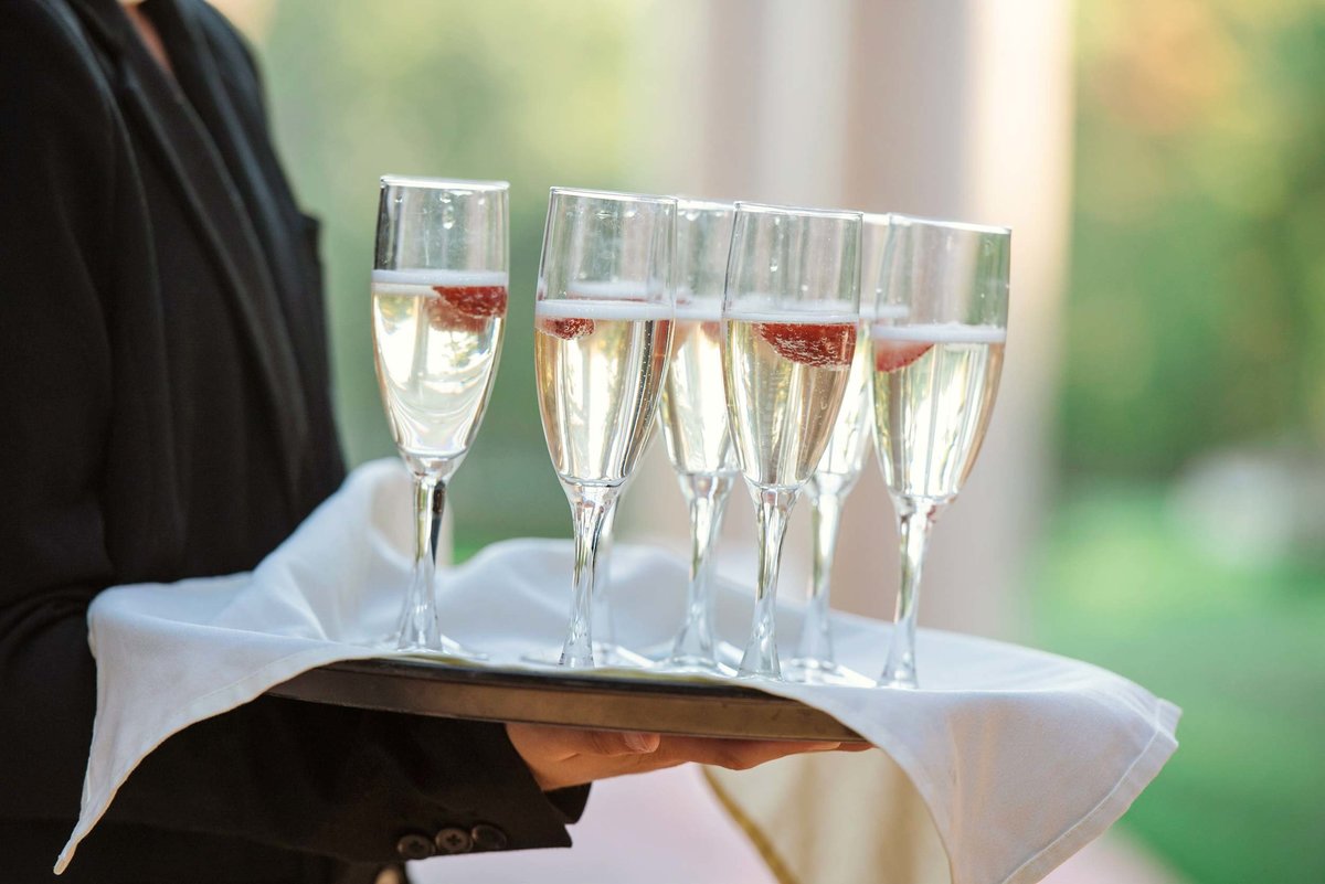 Waiter holding glasses of champagne at Stonebridge Country Club