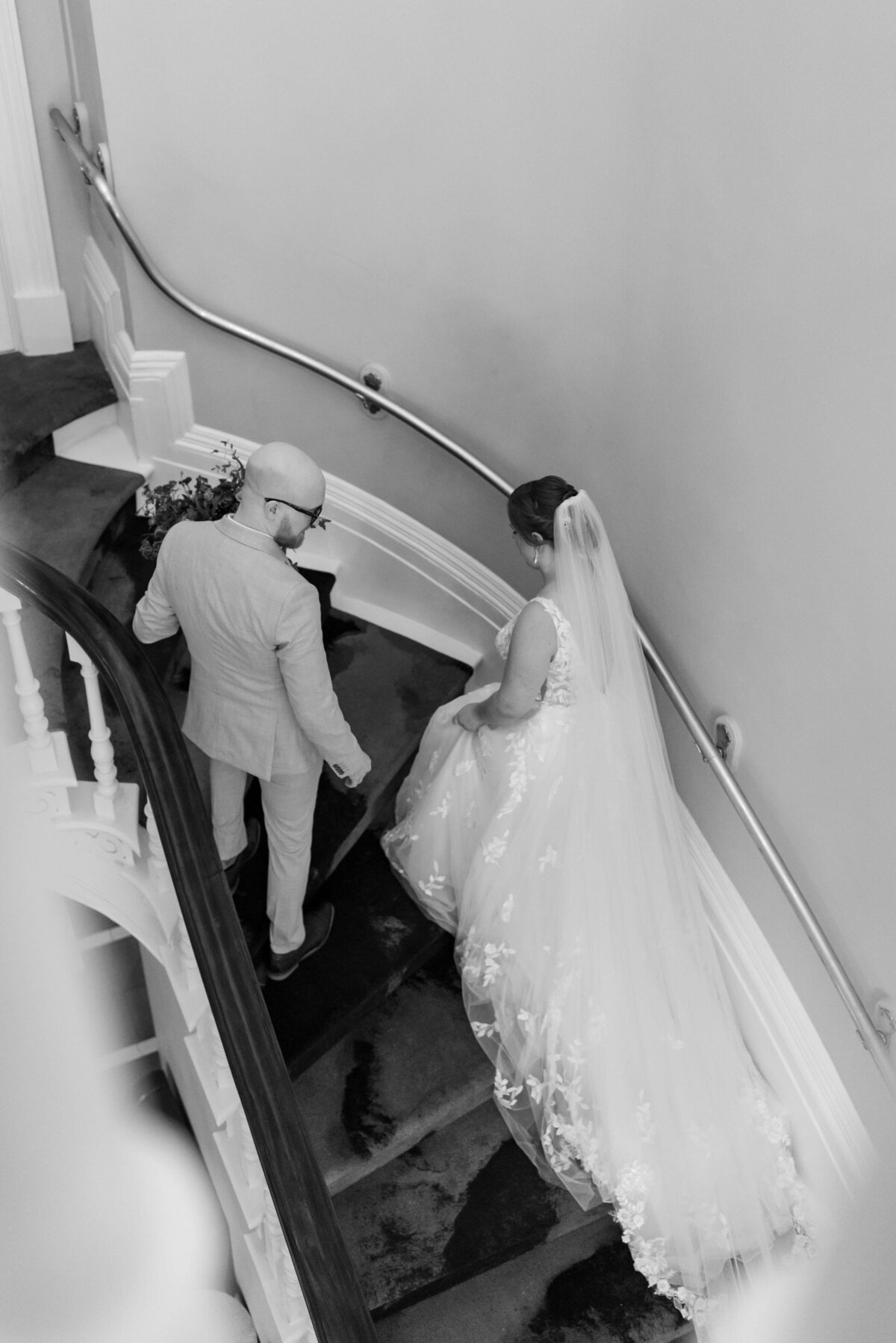 Bride and groom walking up stairs at  at Halifax Club wedding in Nova Scotia