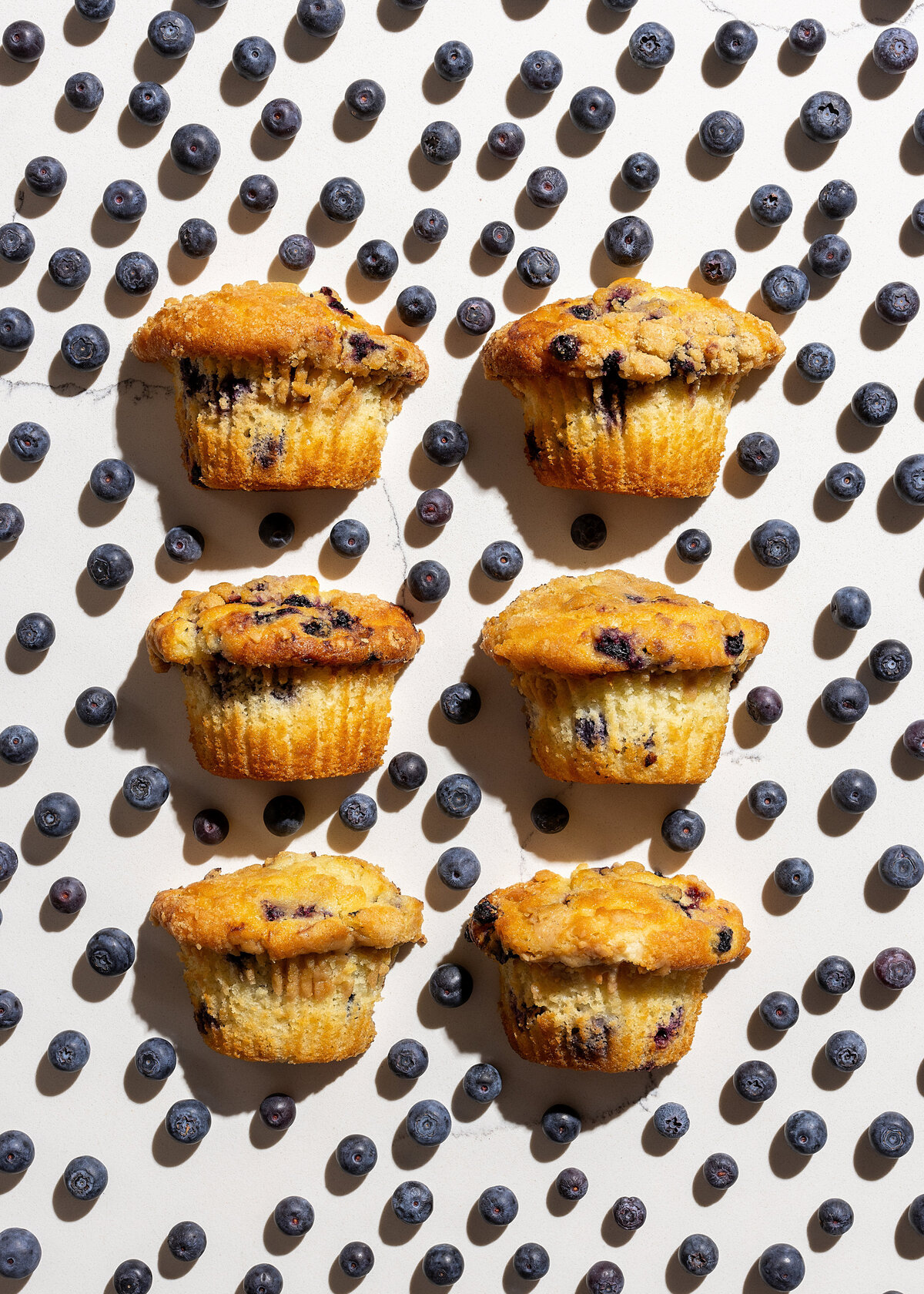 Muffins surrounded by blueberries