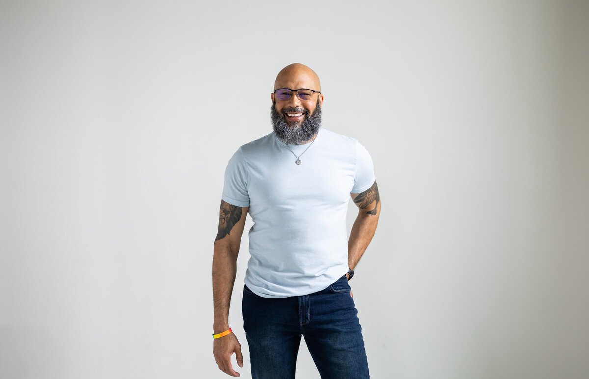 Black man in blue shirt and jeans