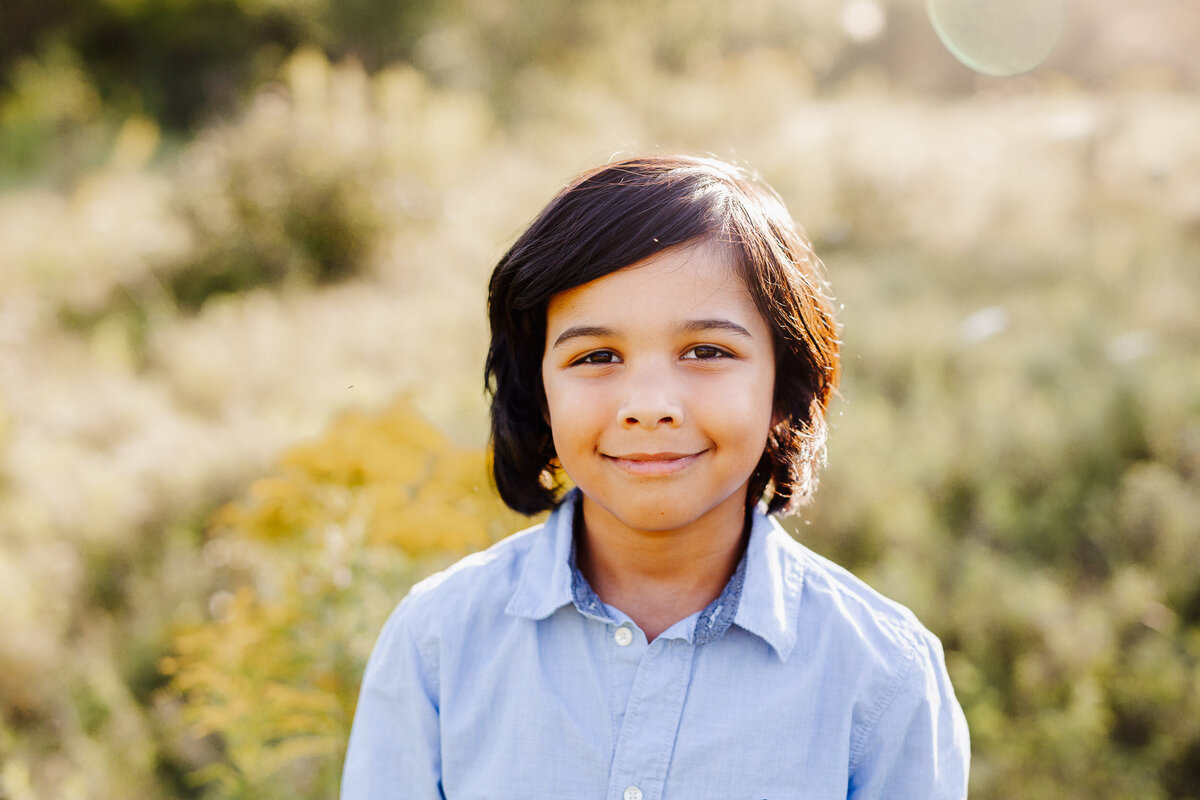 A young boy has his portrait taken during his outdoor photoshoot with Chelsey Kae Photography.