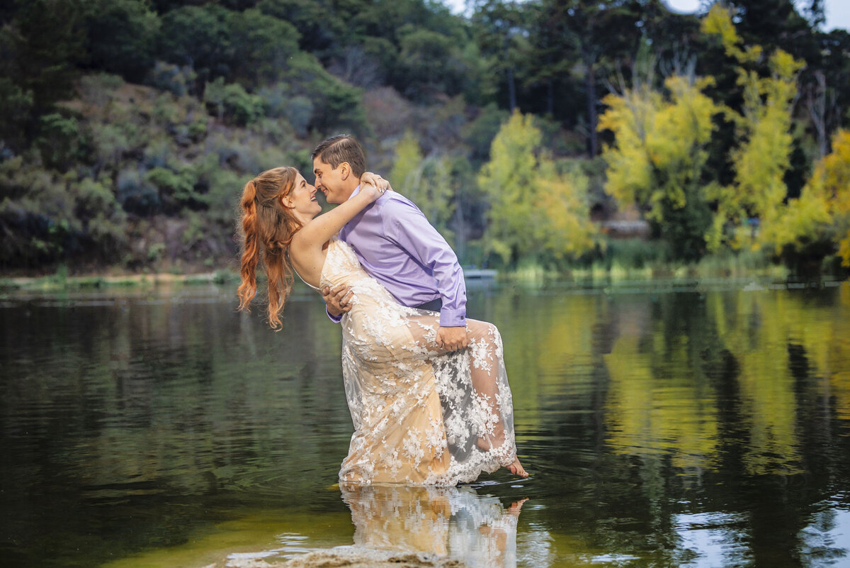 Engaged couple kiss and go in for a dip in the middle of the lake, captured by philippe studio pro, a sacramento wedding photography studio.