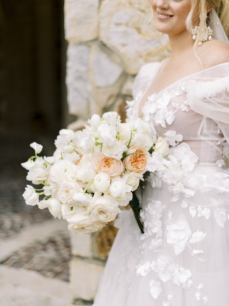 bride holding a bouquet with white and pink flowers