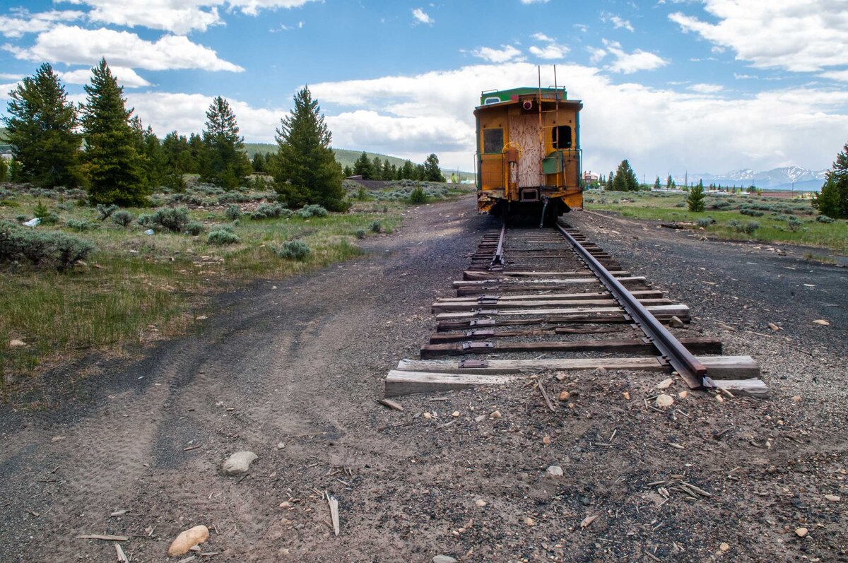 An old train car on track that stops.