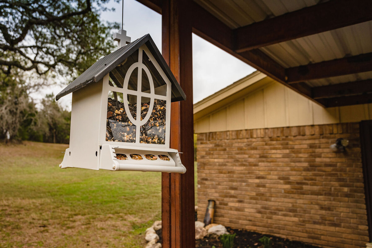 Bird feeder hanging in patio area of this three-bedroom, two-bathroom ranch house for 7 with incredible hiking, wildlife and views.