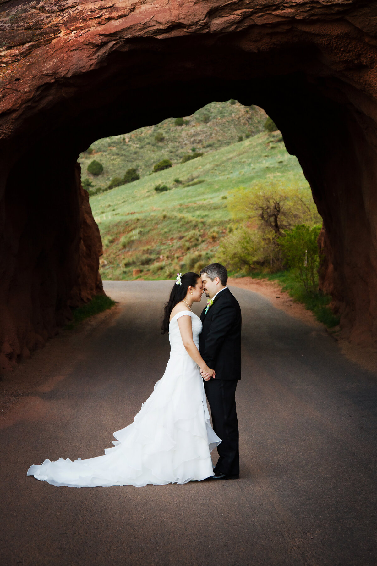 bride & groom in front of the tunnel at Red Rocks Ampitheater