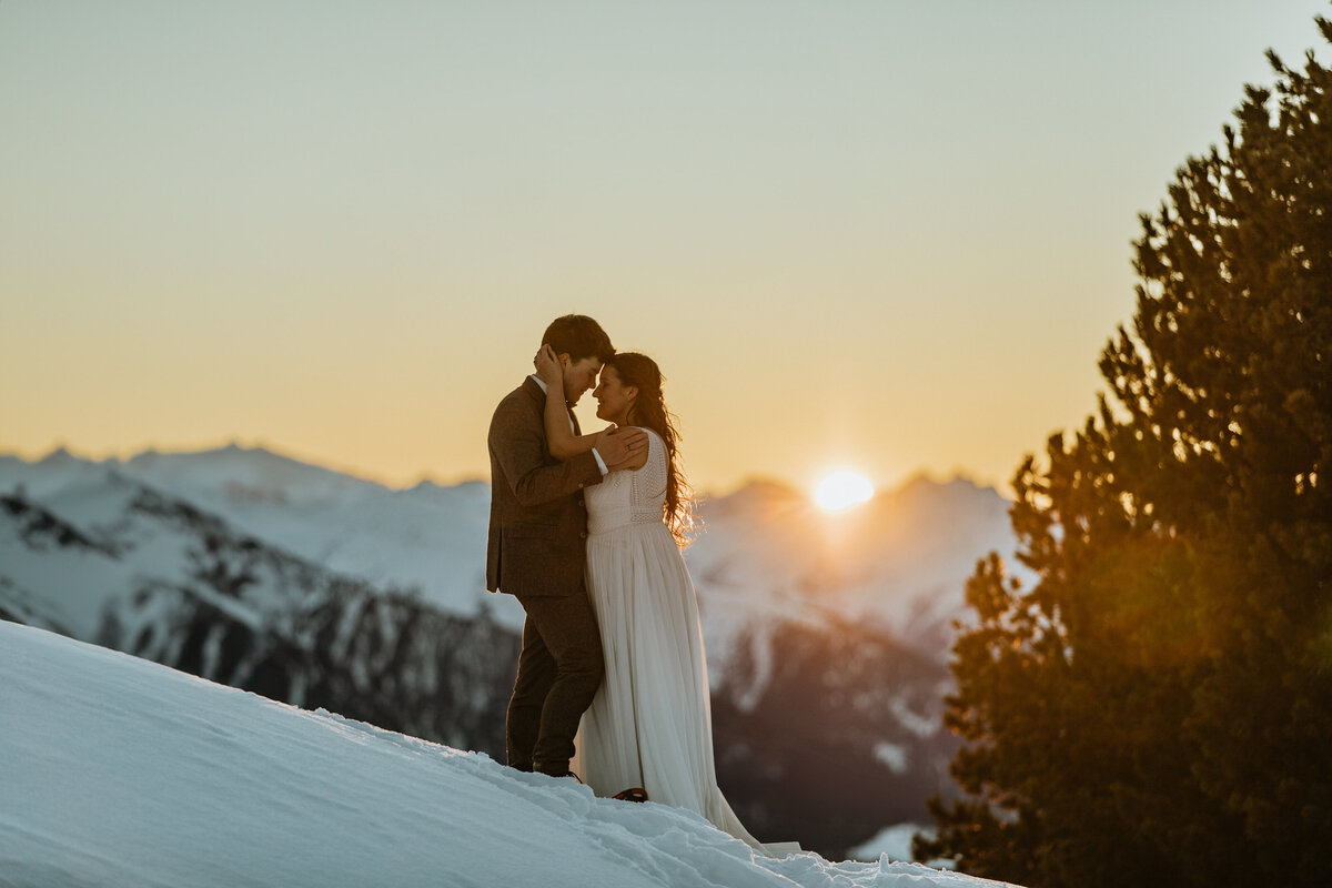 Couple eloping on a mountain in Innsbruck at sunset
