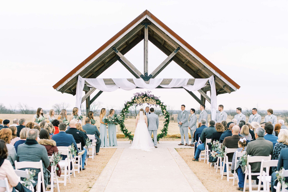Bride and groom stand at altar at outdoor winter wedding in North Texas