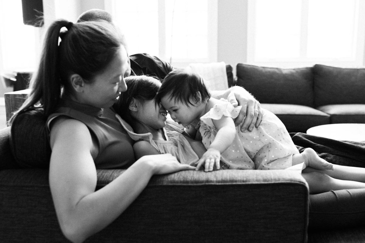 Family of four playing on couch during candid lifestyle family session