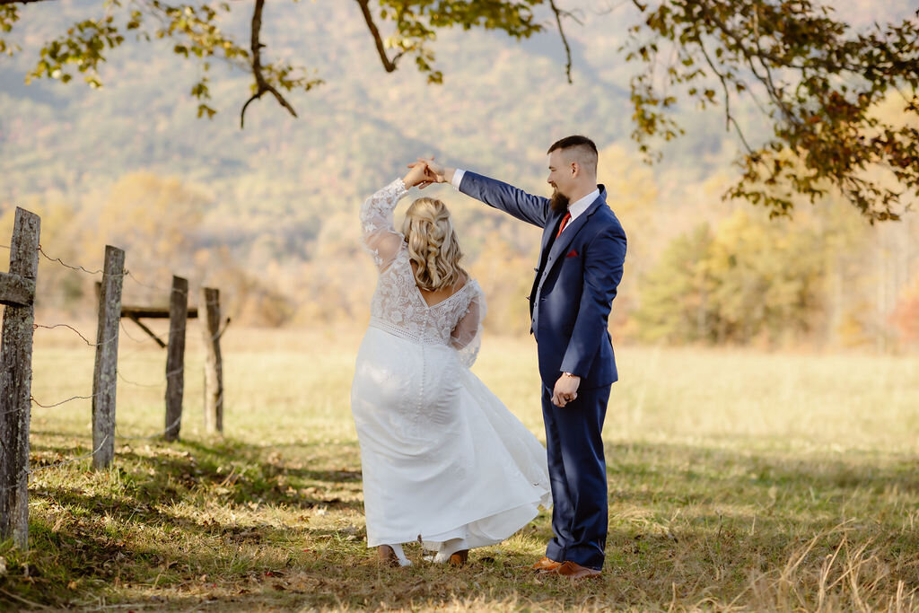 Gatlinburg elopement with couple dancing under trees in a grove in Cades Cove at sunset photographed by photographers in gatlinburg tn