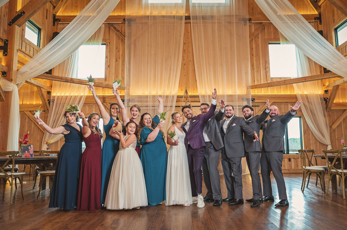 Bridal party with hands in the air at Bear Ridge Destination in Ripley NY.