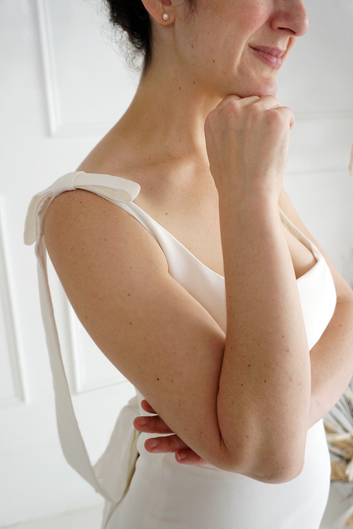Detail shot of the bow shoulder detail on the Jealine crepe wedding gown by indie bridal designer Edith Elan.