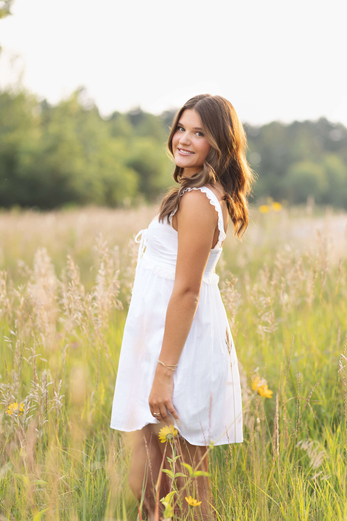 girl in short white dress in long grass