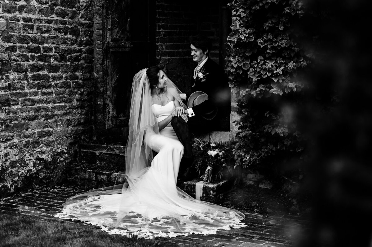 Bride and groom posong in the grounds of Stapleford Park