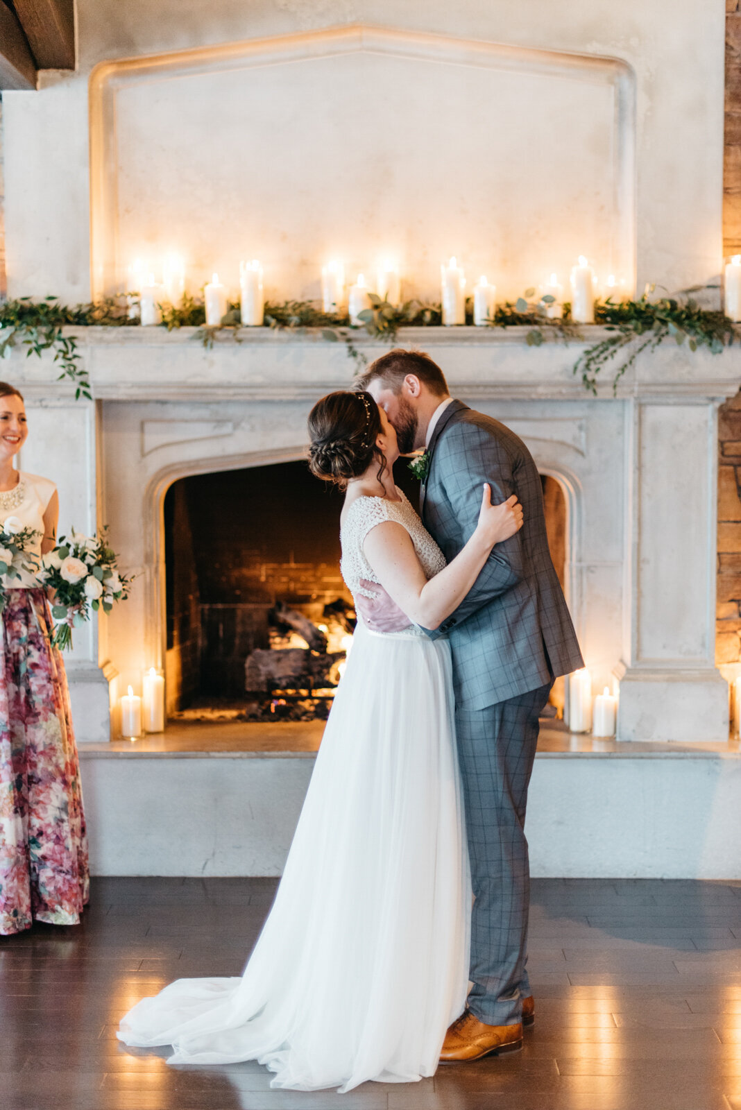 Couple kissing at their indoor wedding ceremony at The Lakehouse, a romantic sophisticated wedding venue in Calgary, featured on the Brontë Bride Vendor Guide.