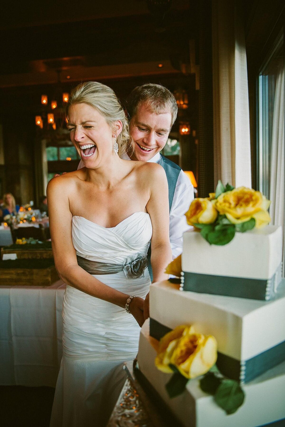 fun cake cutting with bride and groom