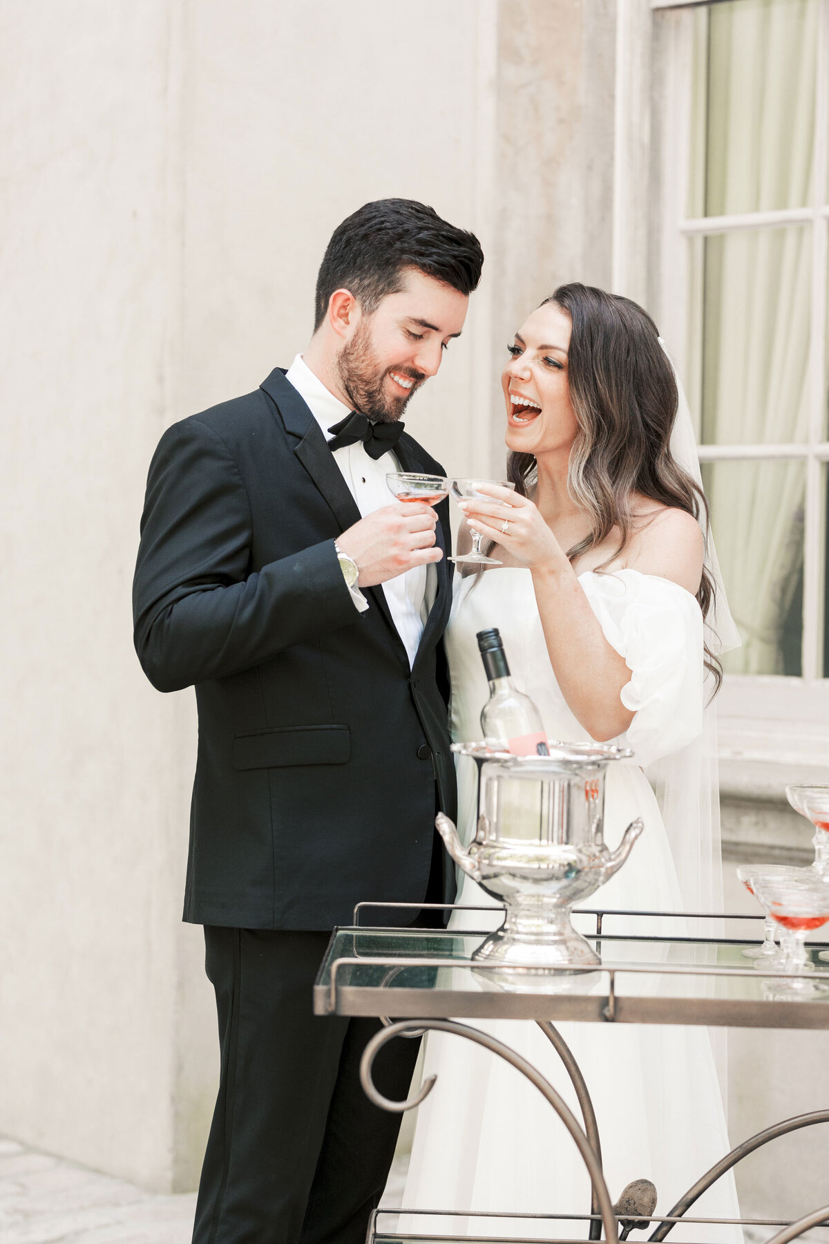 bride and groom toasting champagne at Swan House