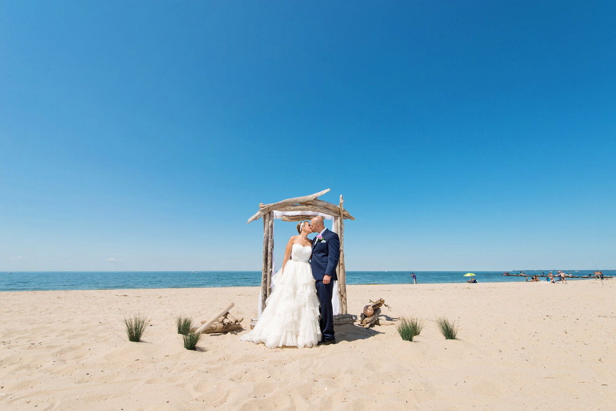 photo of bride and groom on the beach at Pavilion at Sunken Meadow wedding ceremony