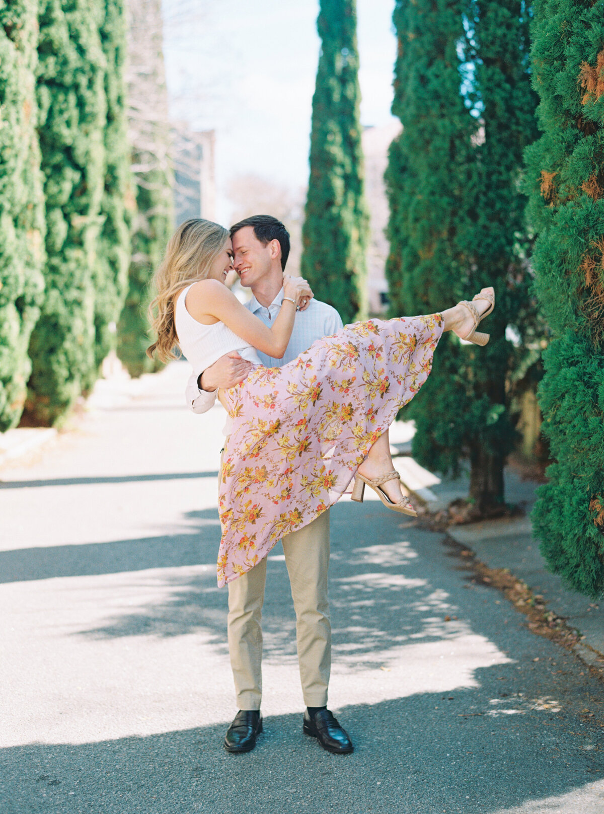 Charleston film photographer. Engagement session in early spring. Perfect classy outfits for engagement session. Pink floral skirt with pop of color design.